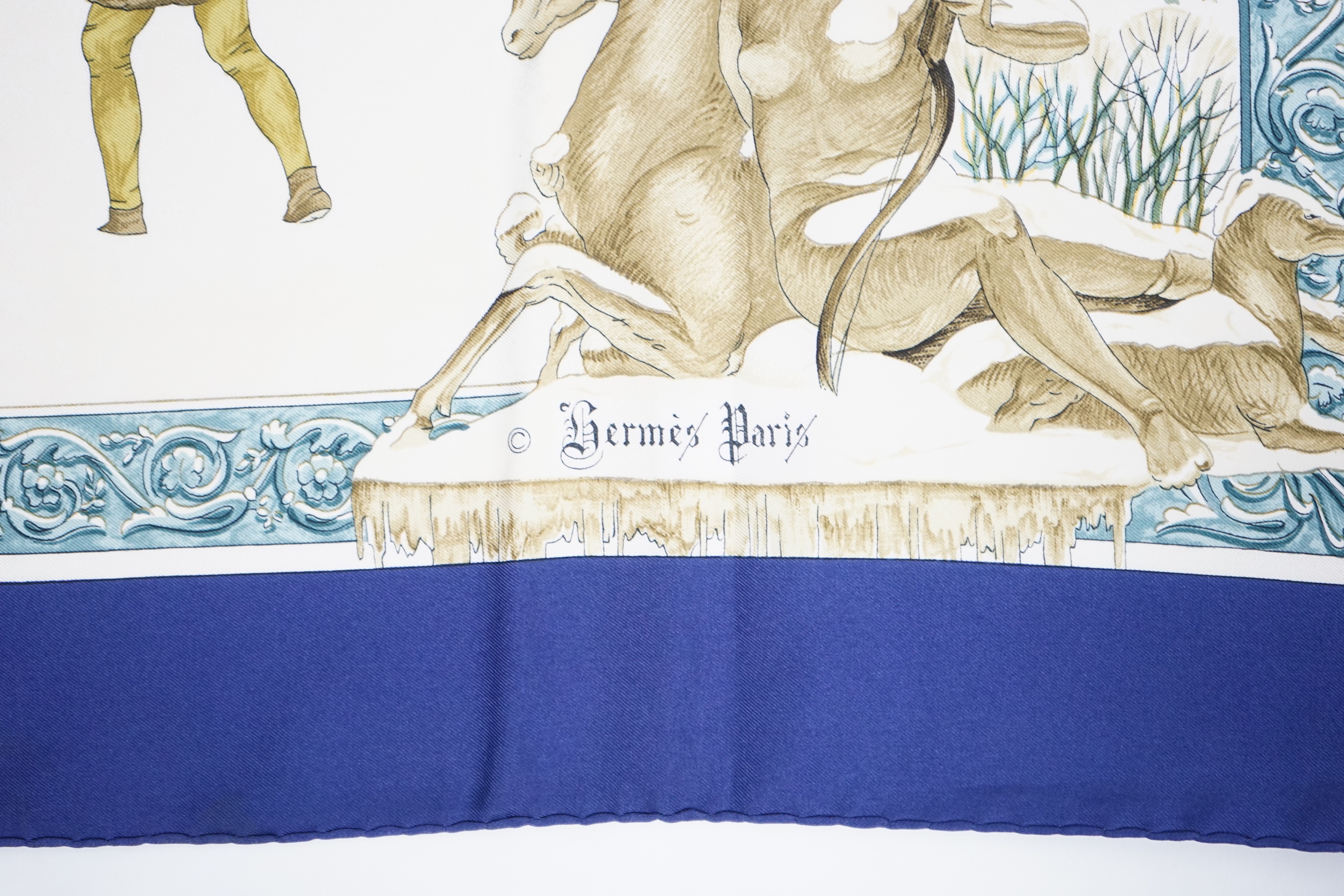A Hermès 'Les Cles Key' blue border multicolour silk scarf and a Hermès Lhiver blue, white and gold silk scarf, both 90cm x 90cm